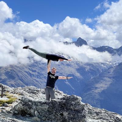 Alex doing a mono hand to hand on Zac Diener on a cliff overlooking the ocean